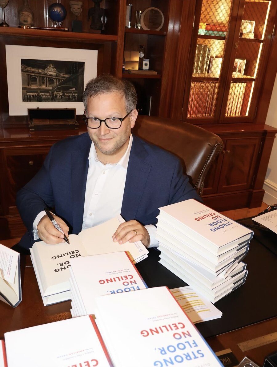 Oliver B. Libby signing copies of Strong Floor, No Ceiling
